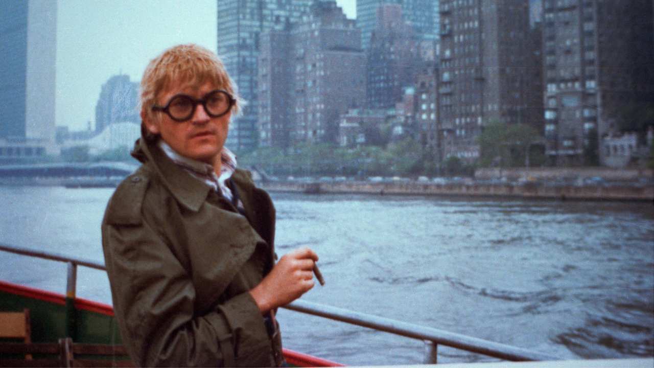 Hockney smoking along a waterfront